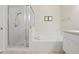 Bright bathroom featuring a glass-enclosed shower and a separate, relaxing soaking tub, creating a spa-like retreat at 19194 Lake Audubon Dr, Tampa, FL 33647
