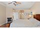 Spacious bedroom with hardwood floors, a ceiling fan, and access to additional rooms, including a bathroom at 19194 Lake Audubon Dr, Tampa, FL 33647