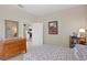 Inviting bedroom with dresser and bookshelf, offering a peek into the adjoining kitchen and home interior at 19194 Lake Audubon Dr, Tampa, FL 33647