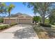 Charming home with a well-maintained lawn, mature landscaping, and a spacious driveway leading to a two-car garage at 19194 Lake Audubon Dr, Tampa, FL 33647