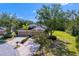 Well-maintained townhome featuring an attached garage, lush greenery, and manicured lawn at 19194 Lake Audubon Dr, Tampa, FL 33647