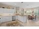 Bright kitchen with white cabinetry, stainless steel appliances, and an adjacent dining area with large windows at 19194 Lake Audubon Dr, Tampa, FL 33647