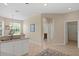 Bright kitchen with white cabinetry and tile flooring, seamlessly connecting to other areas of the home at 19194 Lake Audubon Dr, Tampa, FL 33647