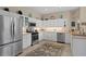 Well-lit kitchen with white cabinets, stainless steel appliances, and tile flooring at 19194 Lake Audubon Dr, Tampa, FL 33647