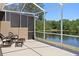 Relax on this screened lanai with comfortable seating and views of the pond at 19194 Lake Audubon Dr, Tampa, FL 33647