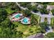 Community pools surrounded by lush green grass, palm trees and neighborhood streets at 19194 Lake Audubon Dr, Tampa, FL 33647