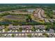 An aerial view showcases the property's location within a residential community near a scenic pond at 20117 Indian Rosewood Dr, Tampa, FL 33647