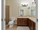 Bathroom featuring tile floor, single vanity with wood cabinets and a glass door shower at 20117 Indian Rosewood Dr, Tampa, FL 33647