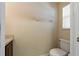 Neat powder room featuring a toilet and vanity near a window, creating a bright space at 20117 Indian Rosewood Dr, Tampa, FL 33647