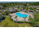 Aerial view of a resort-style community pool with lounge chairs and lush landscaping in a beautiful neighborhood at 20117 Indian Rosewood Dr, Tampa, FL 33647