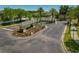Entrance to neighborhood featuring a colorful, landscaped flowerbed at 20117 Indian Rosewood Dr, Tampa, FL 33647