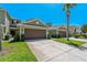 Inviting townhome with a lush lawn, featuring a two-car garage and well-maintained landscaping at 20117 Indian Rosewood Dr, Tampa, FL 33647