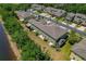 Exterior aerial showcases townhome-style condos featuring neutral tones, manicured lawns, and community street parking at 20117 Indian Rosewood Dr, Tampa, FL 33647