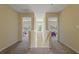 Upstairs hallway with carpet leads to bedrooms and a window with a view of the outdoors at 20117 Indian Rosewood Dr, Tampa, FL 33647