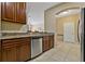 Open concept kitchen with stainless steel dishwasher and granite countertops flowing into living area at 20117 Indian Rosewood Dr, Tampa, FL 33647
