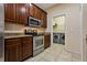 View of kitchen featuring stainless steel oven, microwave, and wooden cabinets at 20117 Indian Rosewood Dr, Tampa, FL 33647