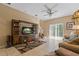 Spacious living room with tile floors, large TV, entertainment center, and sliding glass doors to the outside at 20117 Indian Rosewood Dr, Tampa, FL 33647