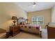 Comfortable bedroom with a ceiling fan, a large window, and neutral decor at 20117 Indian Rosewood Dr, Tampa, FL 33647