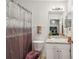 Well-lit bathroom featuring modern fixtures, a vanity, a shower with curtain, and neutral paint at 2050 28Th N Ave, St Petersburg, FL 33713