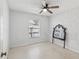 Bright bedroom featuring a ceiling fan, a window, and a large mirror at 2050 28Th N Ave, St Petersburg, FL 33713
