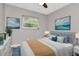 Serene bedroom featuring a comfortable bed, modern decor, two windows and contemporary style at 2054 Deerwood Rd, Seffner, FL 33584