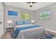 Comfortable bedroom with natural light, ceiling fan, and cool color accents at 2054 Deerwood Rd, Seffner, FL 33584