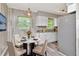 Cozy dining area featuring a round table, contemporary chairs, and plenty of natural light at 2054 Deerwood Rd, Seffner, FL 33584
