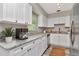 Bright kitchen with white cabinets, marble countertops, and stainless steel appliances at 2054 Deerwood Rd, Seffner, FL 33584