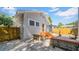 Quaint backyard with a small patio, bench seating, wooden privacy fence and tropical landscaping at 220 19Th S Ave, St Petersburg, FL 33705
