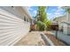 Side view of the backyard with a paver walkway and a charming wooden gate at 220 19Th S Ave, St Petersburg, FL 33705