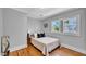 Cozy bedroom with a double bed, hardwood floors, a window, and gray walls at 220 19Th S Ave, St Petersburg, FL 33705