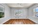 Bedroom featuring hardwood floors, white walls, and lots of natural light at 220 19Th S Ave, St Petersburg, FL 33705