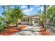 Well-maintained home featuring a covered carport, stone pathway, and lush landscaping at 220 19Th S Ave, St Petersburg, FL 33705