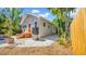 Charming exterior showcasing a well-maintained yard with stone accents, a wooden fence and steps to the home at 220 19Th S Ave, St Petersburg, FL 33705