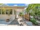 View of the exterior side of the home with stone pathway, manicured shrubbery, and fencing at 220 19Th S Ave, St Petersburg, FL 33705
