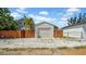 Detached garage with a roll-up door, surrounded by a wooden fence and white gravel at 220 19Th S Ave, St Petersburg, FL 33705
