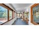 Bright sunroom featuring vintage trim, large windows and an elegant ceiling fan at 220 19Th S Ave, St Petersburg, FL 33705