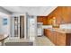 Kitchen with white appliances, vintage cabinets and patterned flooring at 220 19Th S Ave, St Petersburg, FL 33705