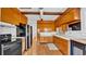 Traditional kitchen with honey-toned cabinetry, a double-door refrigerator, and hardwood floors at 220 19Th S Ave, St Petersburg, FL 33705