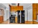This kitchen features wood floors, wood cabinets, black appliances, and a window above the sink at 220 19Th S Ave, St Petersburg, FL 33705