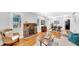 Bright living room featuring hardwood floors, a brick fireplace, and ample natural light at 220 19Th S Ave, St Petersburg, FL 33705