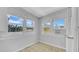 Bright sunroom featuring multiple windows, light tile flooring, and an air conditioning unit at 220 19Th S Ave, St Petersburg, FL 33705