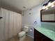 Bathroom featuring a bathtub, glass countertop vanity, and tiled walls around the tub at 2333 Feather Sound Dr # B104, Clearwater, FL 33762