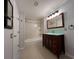 Bathroom featuring modern vanity with glass countertop, tiled shower and tub, and modern hardware at 2333 Feather Sound Dr # B104, Clearwater, FL 33762