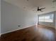 Neutral bedroom with wood floors, a ceiling fan, recessed lights, and large window with blinds at 2333 Feather Sound Dr # B104, Clearwater, FL 33762