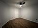Bedroom with wood floors, ceiling fan, and white door at 2333 Feather Sound Dr # B104, Clearwater, FL 33762