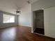 Spacious bedroom features laminate wood flooring, ceiling fan, closet with sliding doors, and a bright window at 2333 Feather Sound Dr # B104, Clearwater, FL 33762