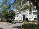 Beautiful condominium building with tropical landscaping and covered entrance for easy access to the property at 2333 Feather Sound Dr # B104, Clearwater, FL 33762