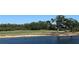 Serene water view overlooking the golf course, with mature trees enhancing the beautiful, natural scenery at 2333 Feather Sound Dr # B104, Clearwater, FL 33762