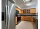 Updated kitchen with stainless steel appliances, wood cabinets with glass features, and gorgeous countertops with tile backsplash at 2333 Feather Sound Dr # B104, Clearwater, FL 33762